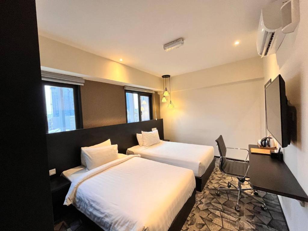 Postel nebo postele na pokoji v ubytování Hotel Damai Kuala Lumpur