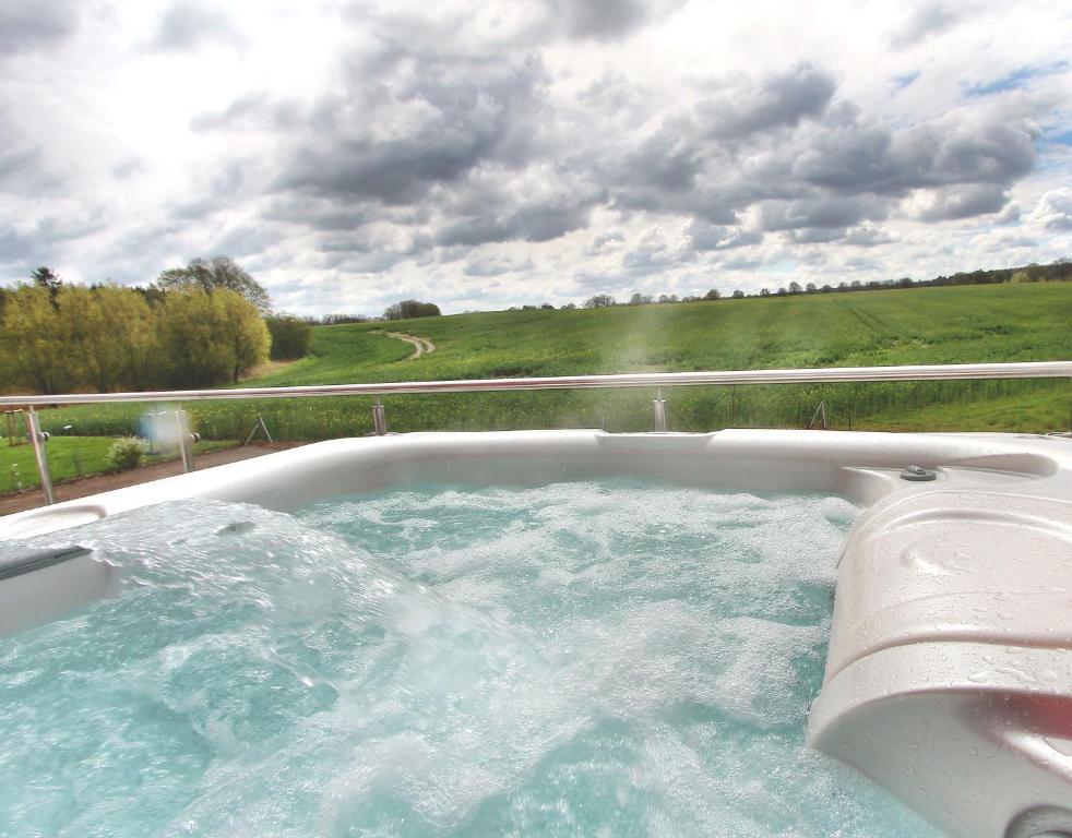 a jacuzzi tub with a view of a field at Villa Grande Fewo Relax We 4 in Göhren-Lebbin