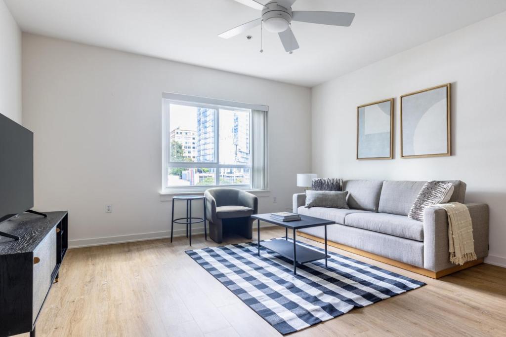 a living room with a couch and a table at Downtown Bellevue 2BR w WD Rooftop nr all SEA-141 in Bellevue