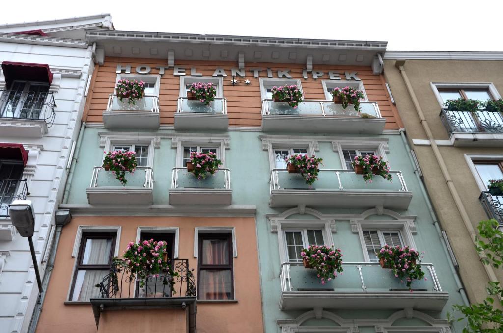 an apartment building with flower boxes on balconies at Antik Ipek Hotel in Istanbul