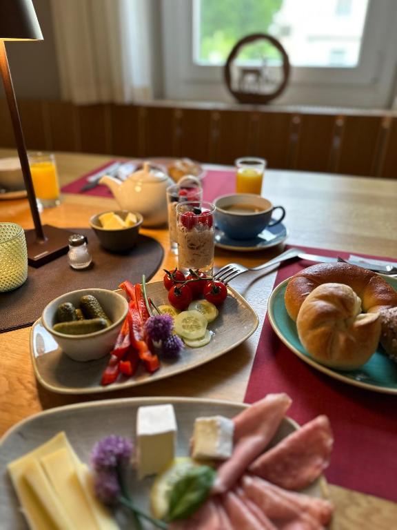 a wooden table with plates of food on it at Gasthof - Auszeit im Bad Diezlings - Adults only in Hörbranz