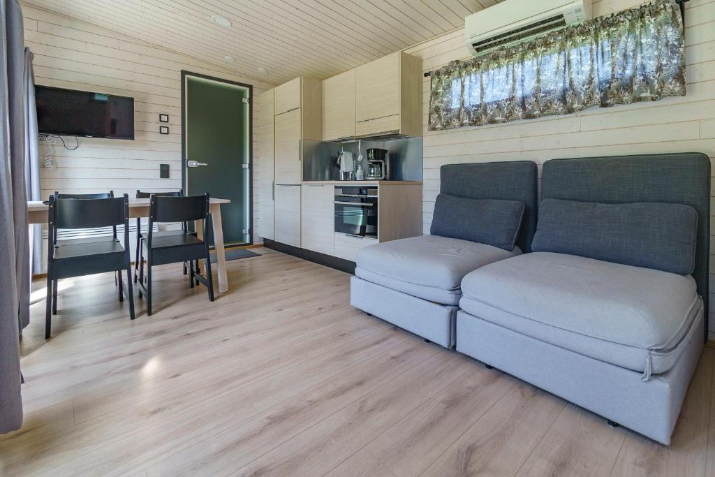 a living room with a couch and a table at Rauhalahti Holiday Homes in Kuopio