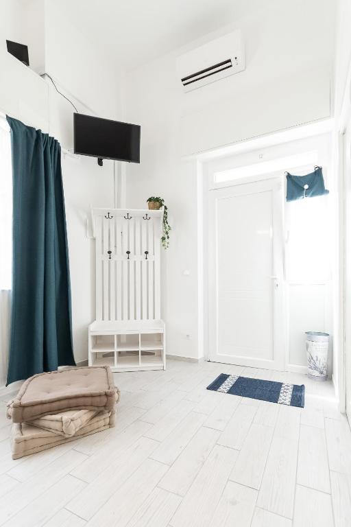 a white room with a door and a bed in it at Sea Loft Quinto - A due passi dal mare in Genoa