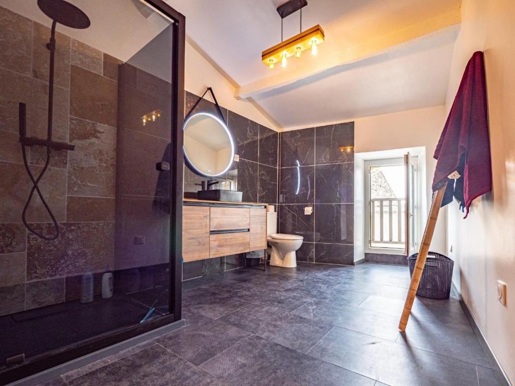 a bathroom with a shower and a sink and a mirror at Chez Romain et Saphie in Les Baux-de-Provence