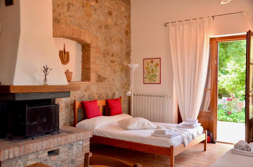 a bedroom with two beds and a fireplace at Agriturismo Cornieto in Monteleone dʼOrvieto
