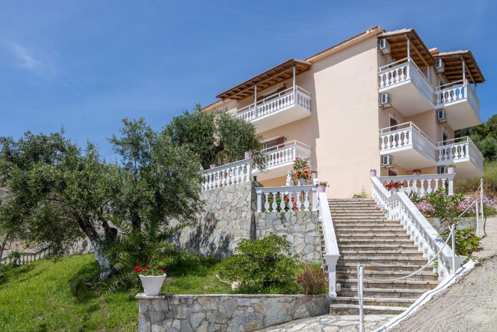 a villa with stairs to the front of the house at Corfu Panorama by Estia in Moraitika