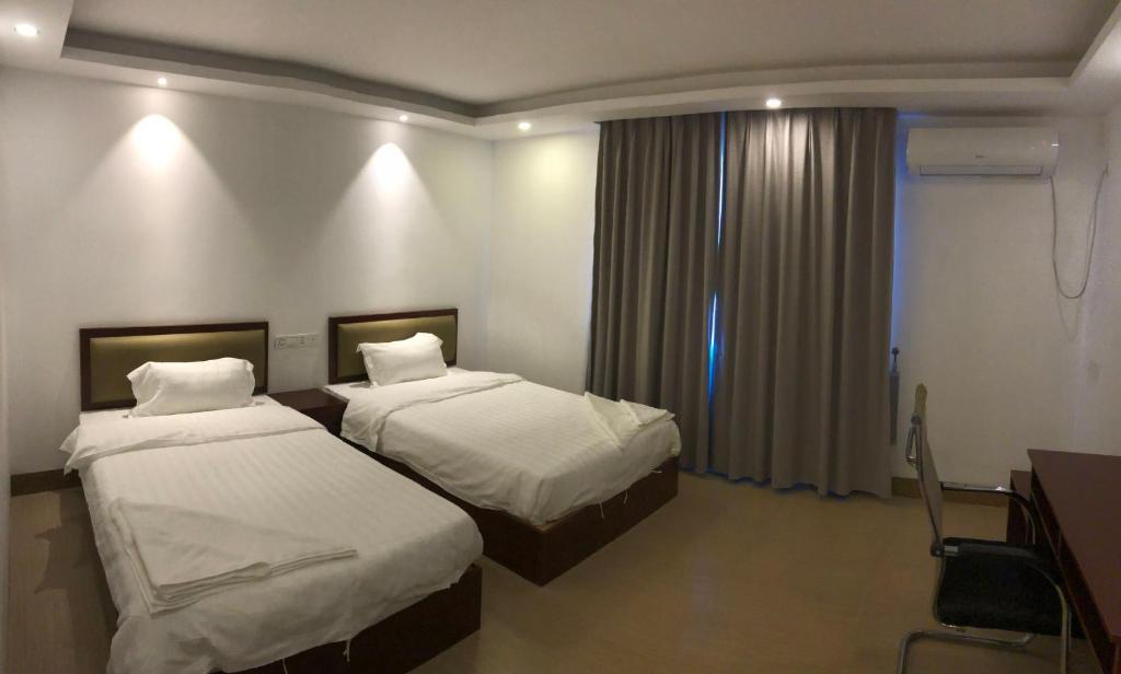 Postel nebo postele na pokoji v ubytování Yaou Hotel