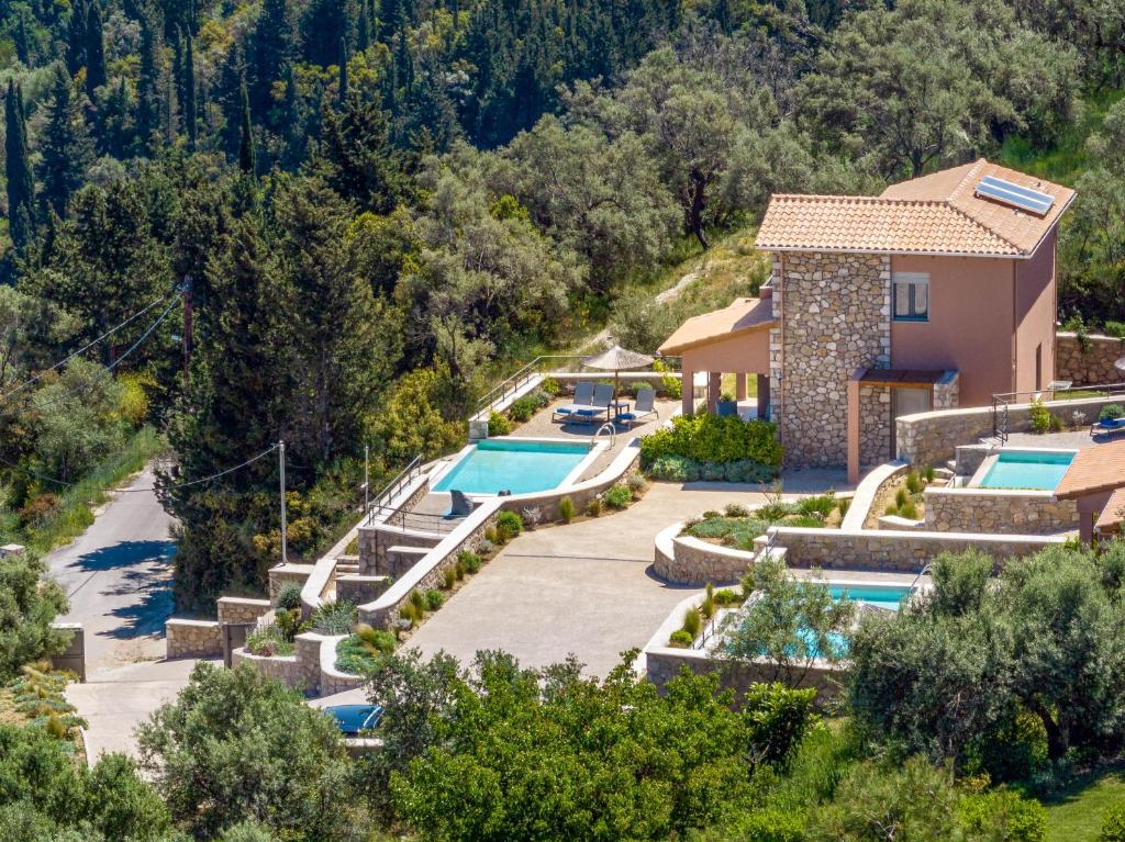 an aerial view of a resort with a swimming pool at 31 Blue Ionian Villas in Apolpaina