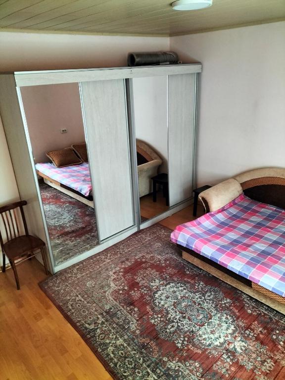 A bed or beds in a room at Гостевой дом У Матвея