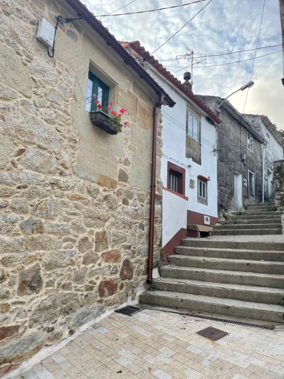 a stone building with stairs and a window at Casa Dulce in Porto do Son