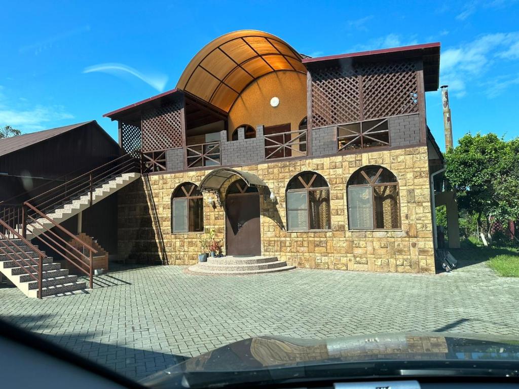 a building with a dome on top of it at Gostevoy Dom in Pizunda