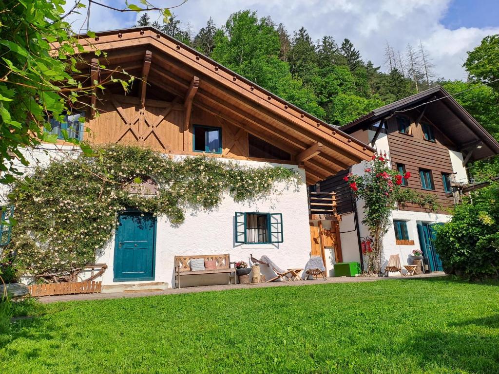 a house with a blue door and a green yard at Chalet Passeier - ZOLL in Saltusio