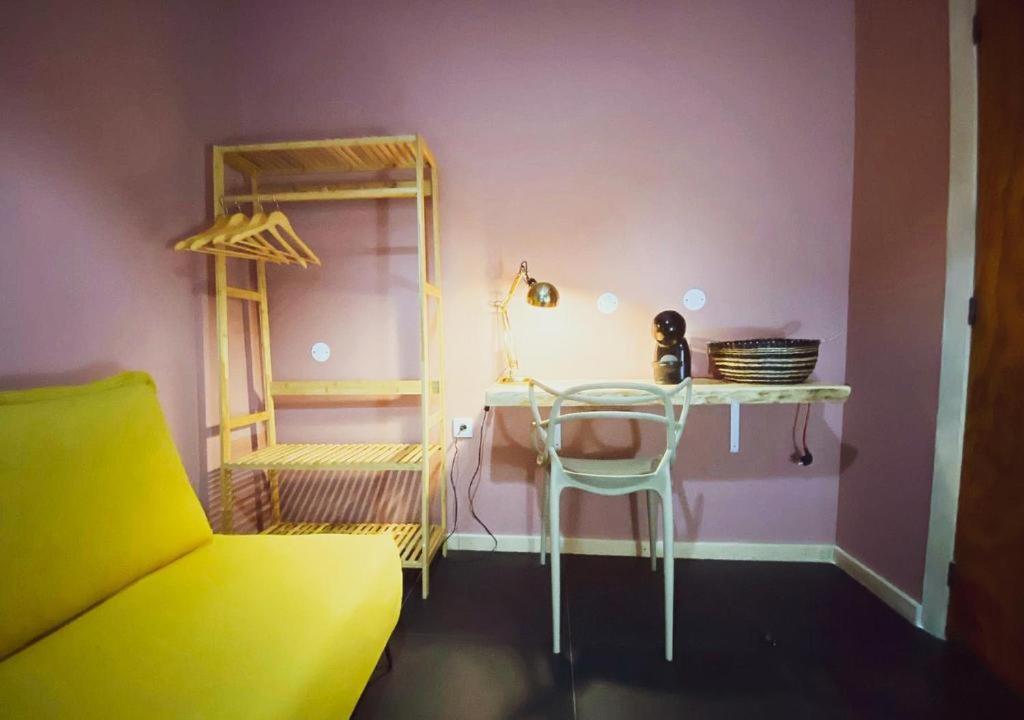 a room with a table and a chair and a shelf at Porto Santo Destination in Porto Santo