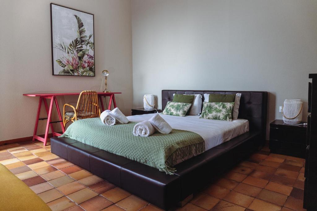 a bedroom with a bed with towels on it at Porto Santo Destination in Porto Santo