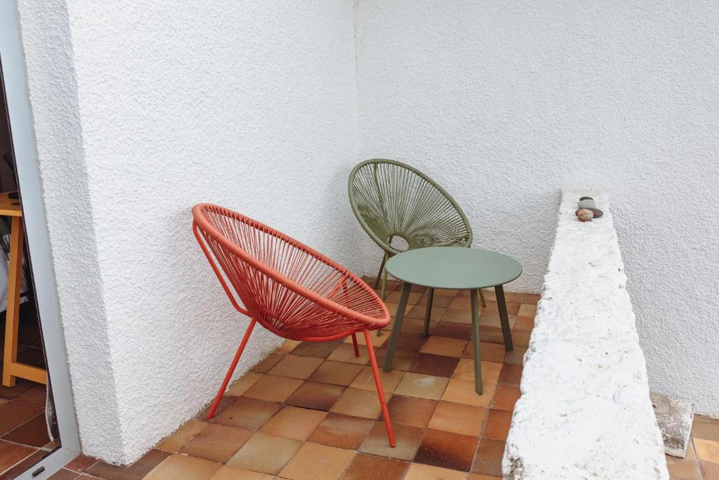 two chairs and a table in a room at Porto Santo Destination in Porto Santo