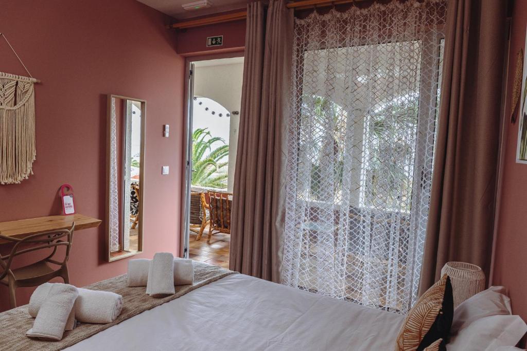 a bedroom with a bed and a large window at Porto Santo Destination in Porto Santo