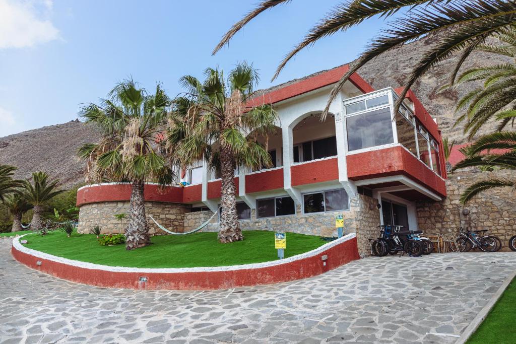 a building with palm trees in front of it at Porto Santo Destination in Porto Santo