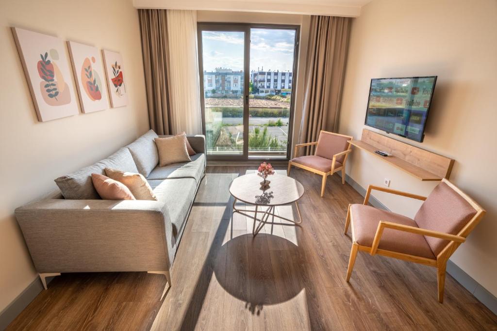 un salon avec un canapé et une table dans l'établissement LARA MARİNE HOMES, à Antalya