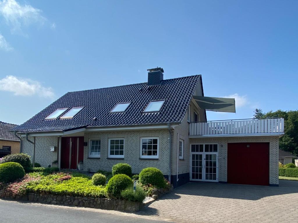 a house with a roof with a garage at Studio - a79311 in Loxstedt