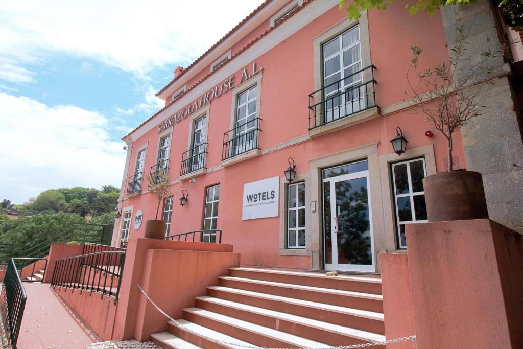 un edificio rosa con escaleras delante en WOT Sintra Sarrazola, en Sintra