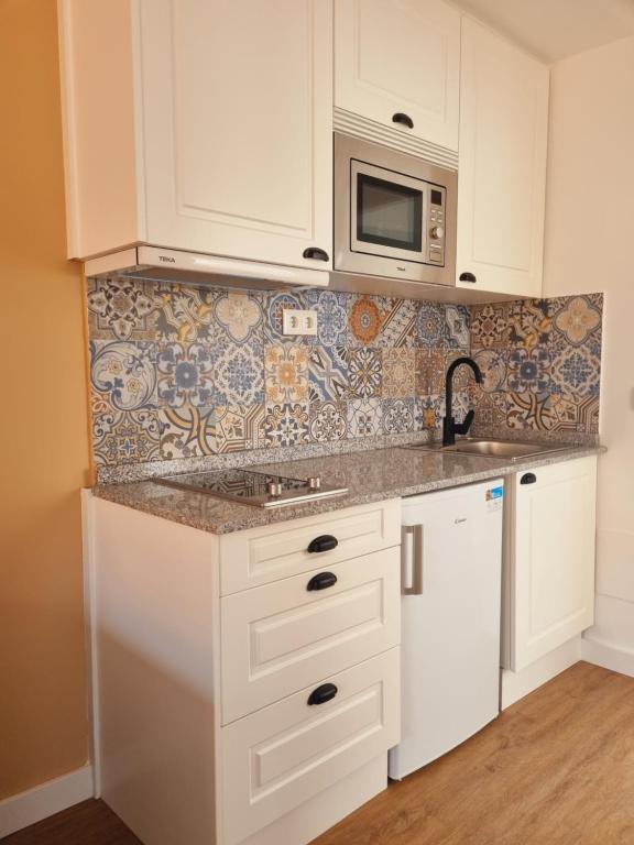 Kuchyň nebo kuchyňský kout v ubytování Maile Apartamentos