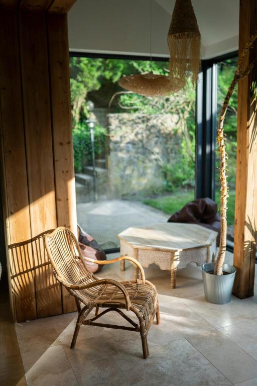 a room with a chair and a table and a window at BlissHouse Luxurious Guesthouse calm and energetic spot near by city surrounded by the forest where you will find your peace and your people in Krakow