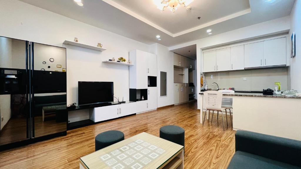 a large kitchen and living room with white cabinets at Homestay Times City 04T1N in Hanoi