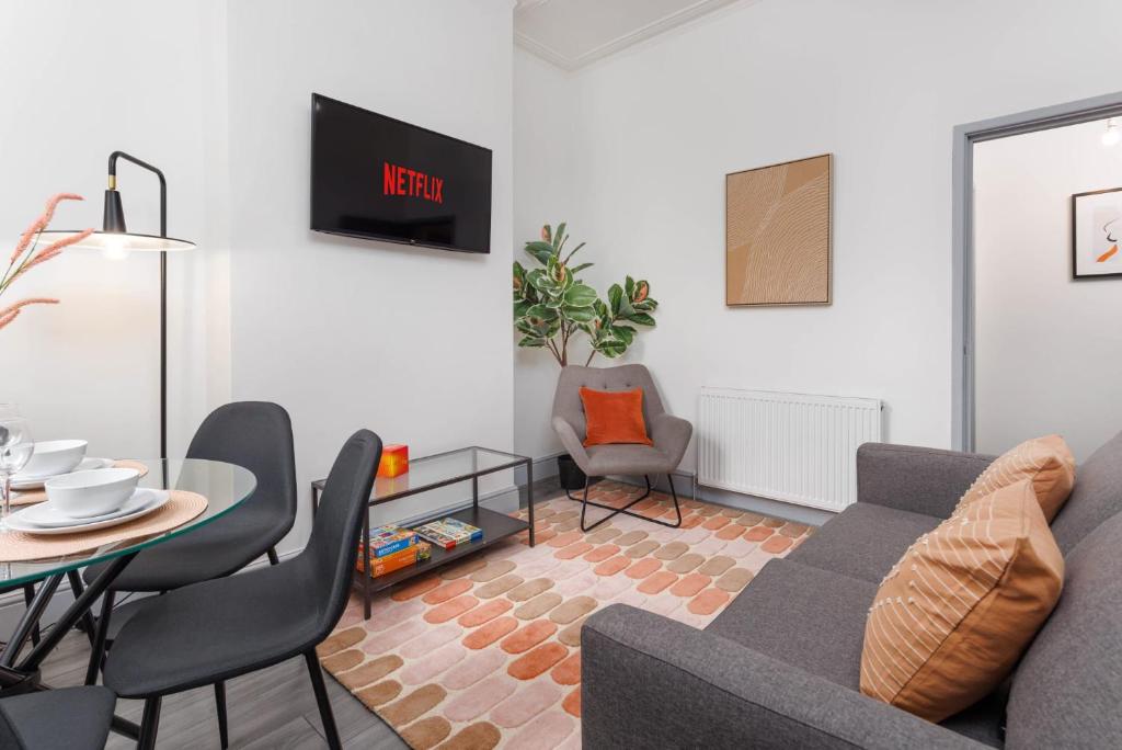 a living room with a couch and a table at Newly Renovated Apartments in Liverpool - Extended Stay in Liverpool