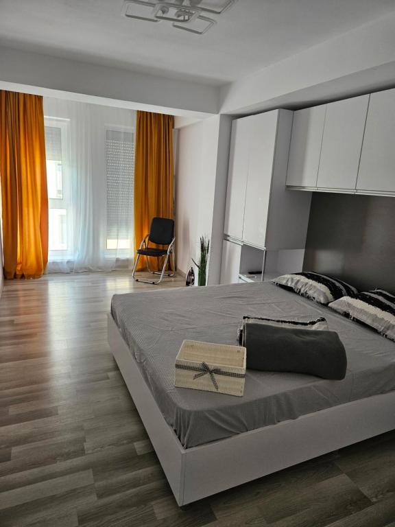 a bedroom with a large bed with white cabinets at Bella Apartament in Constanţa