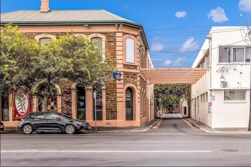 a car parked on a street in front of a building at The Hidden Gem - Adelaide CBD in Adelaide