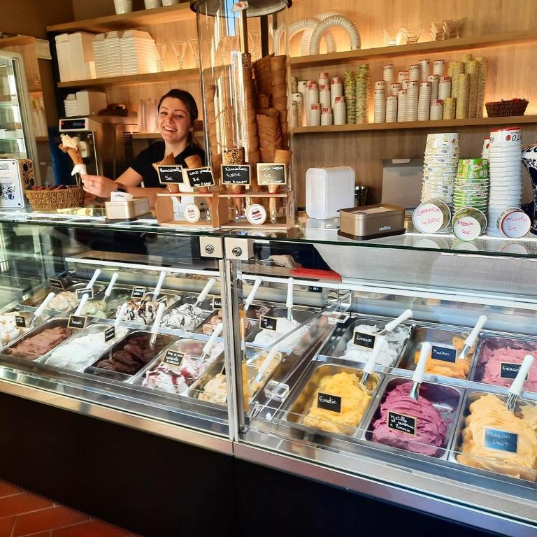 a woman standing behind the counter of a bakery at Poggio all'Agnello Sport & Family Holidays in Populonia