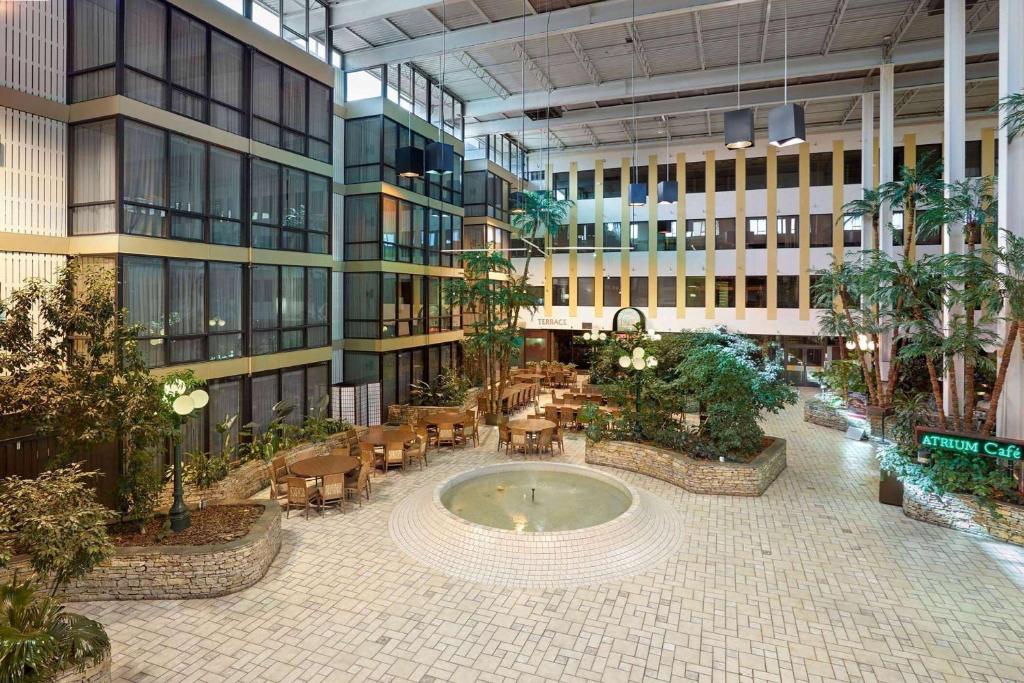 a large building with a courtyard with a fountain in it at Wyndham Edmonton Hotel and Conference Centre in Edmonton