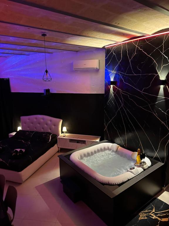 a room with a jacuzzi tub and a couch at Sassi di Matera Dimora Sovrana - Deluxe Suite in Matera