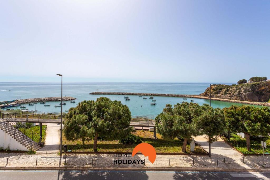 a view of the ocean from the balcony of a resort at #114 T2 Foxy H by Home Holidays in Páteo