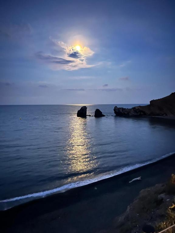 un coucher de soleil sur l'océan avec des rochers dans l'eau dans l'établissement Cap d' Agde La conque, au Cap d'Agde