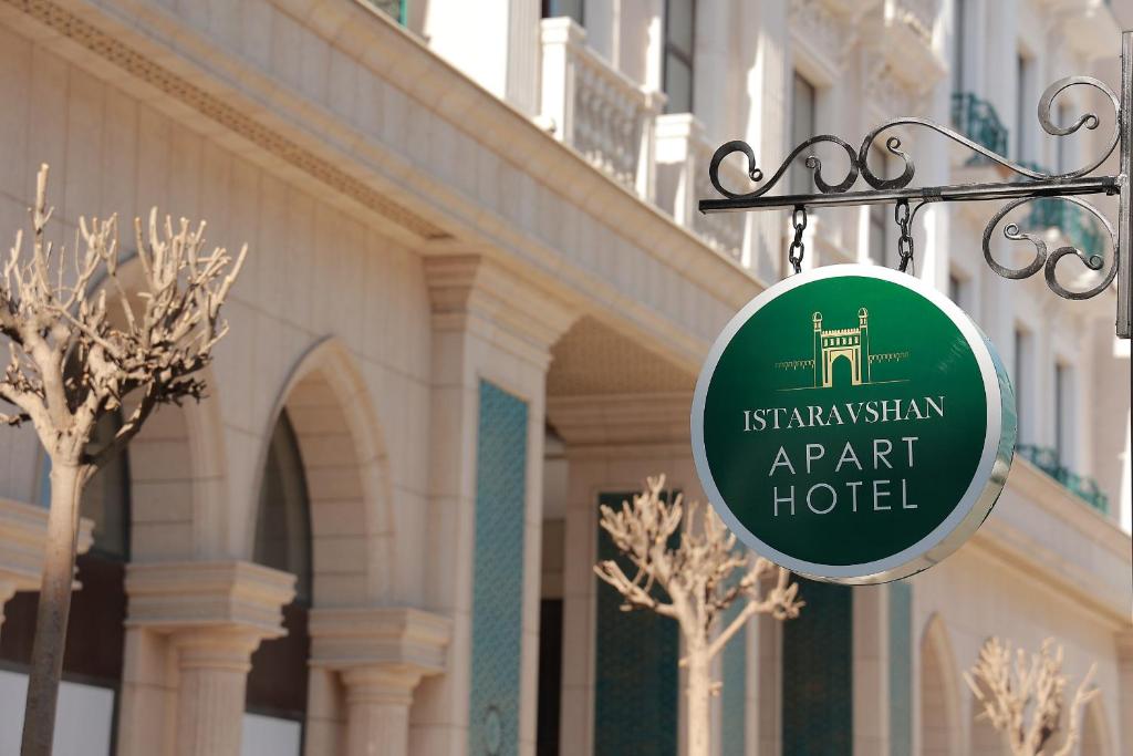 a sign for an apartment hotel hanging in front of a building at Apart Hotel Istaravshan in Tashkent