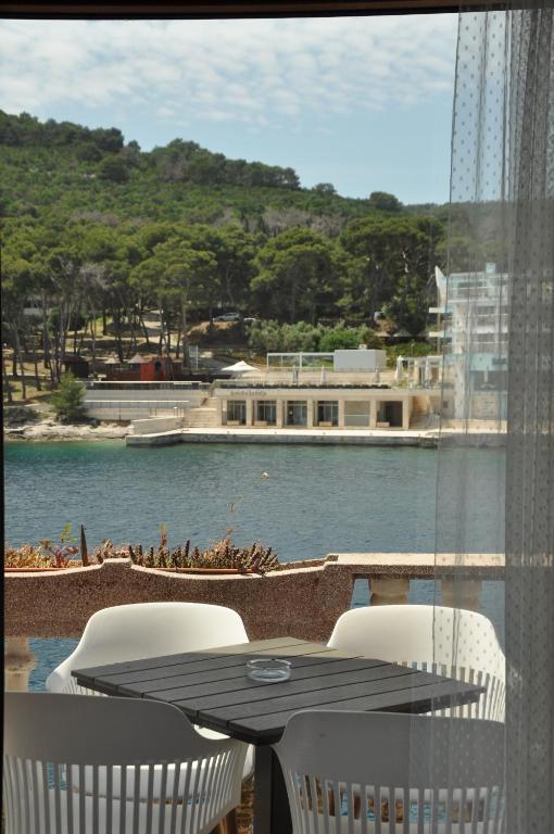 a table and chairs with a view of a body of water at Jungle & Sea Boxavia in Božava