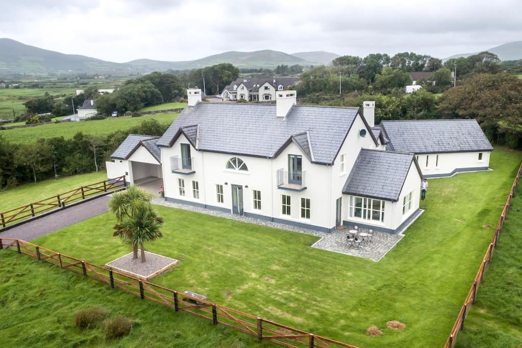 an aerial view of a white house on a green field at Country Setting in the Middle of Dingle Town. in Dingle