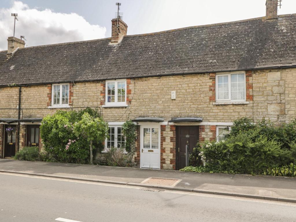an old brick house on the side of a street at Wharf Cottage in Lechlade