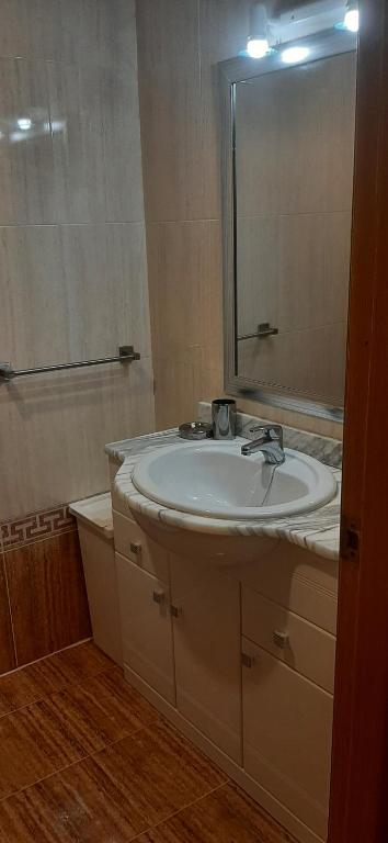 a bathroom with a sink and a mirror at Oasis en la cala a pasos de mar!! in Cala de Finestrat