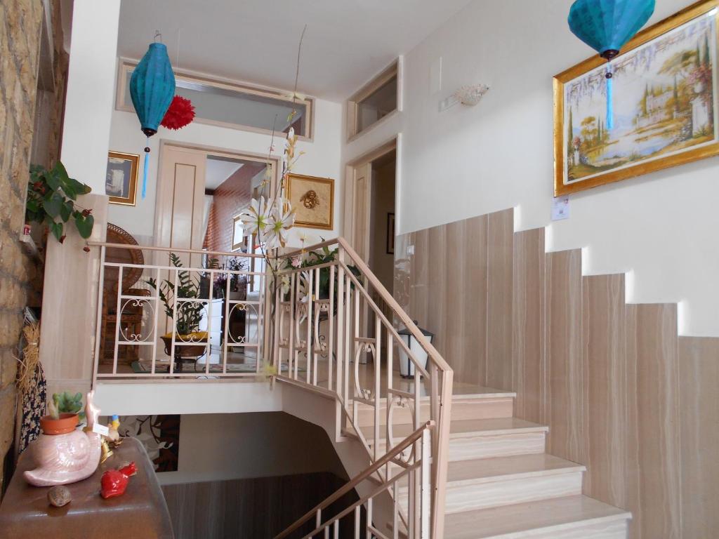 a staircase in a home with a white and wooden stair case at Le Chiocciole in Sannicandro di Bari