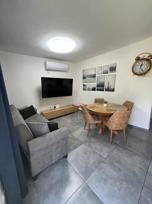 a living room with a couch and a table at Galilee sea Sunset Suites in Migdal