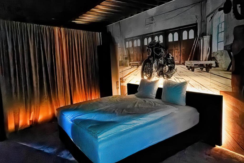 a bedroom with a bed with a motorcycle on the wall at SINATRA CIGAR HOUSE in Banská Bystrica