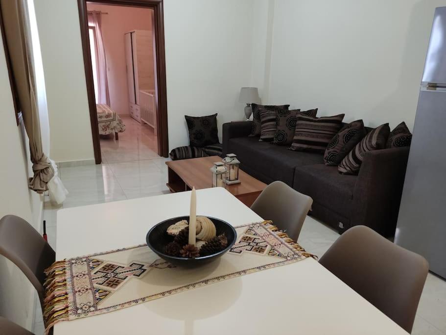 a living room with a table with a candle on it at Renovated apartment 300m from the sea in Ierissos