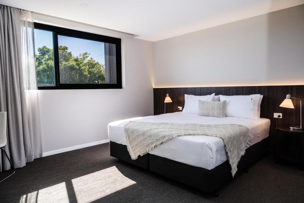 a bedroom with a large bed and a window at 107 George in Kalbar