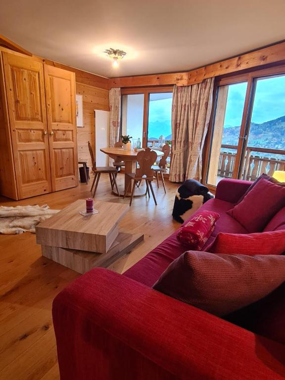 a living room with a couch and a table at Le Bristol - Villars Bristol Apartments in Villars-sur-Ollon