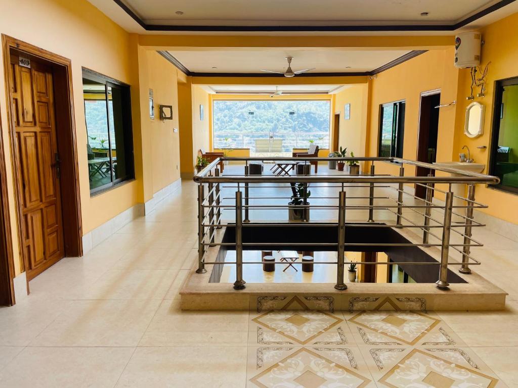 a hallway with a staircase in a house at Kashmir Heaven Guest House in Muzaffarabad