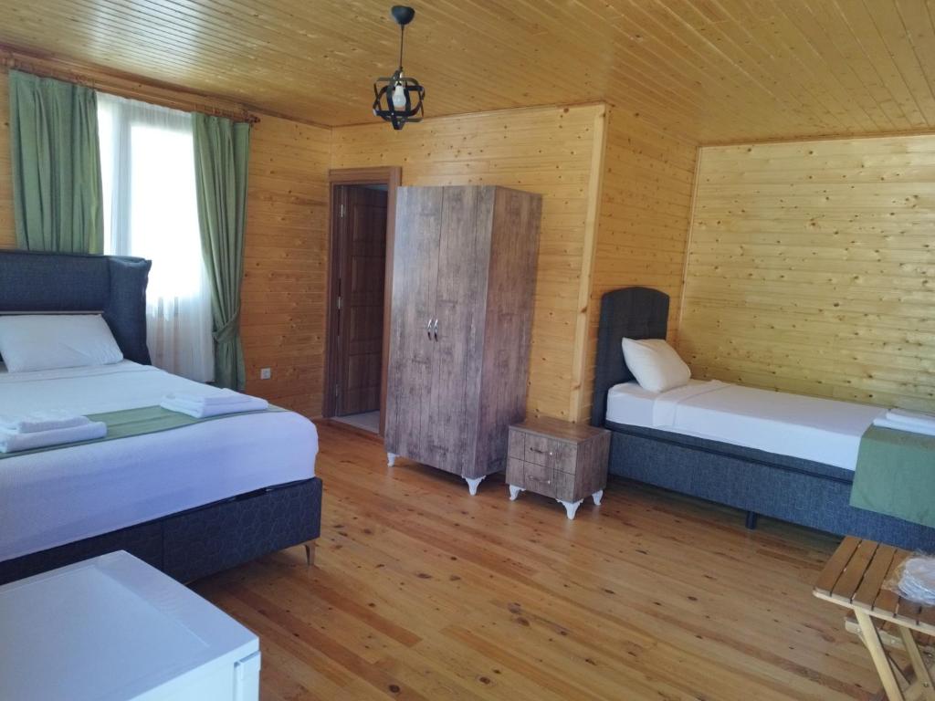 Postel nebo postele na pokoji v ubytování Kandyba restoran & bungalov