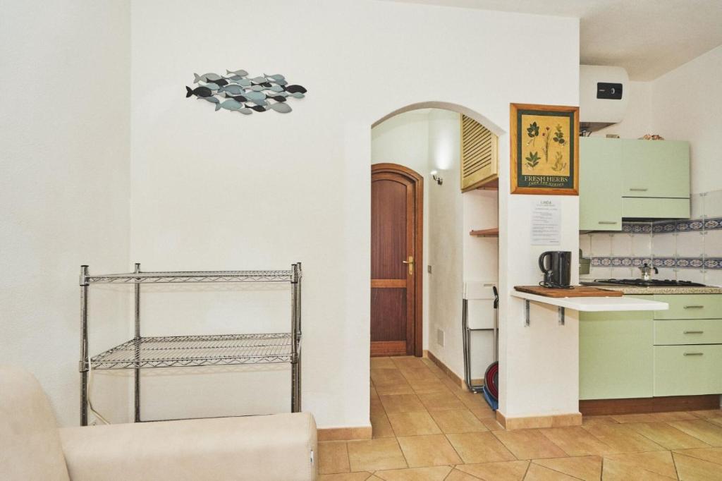 a kitchen with green cabinets and a counter top at LA CASA DI LINDA in Porto Ottiolu