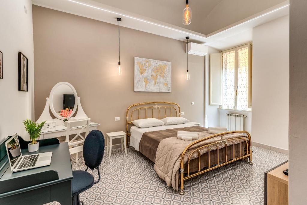 een slaapkamer met een bed, een bureau en een laptop bij Rhome Colosseum in Rome